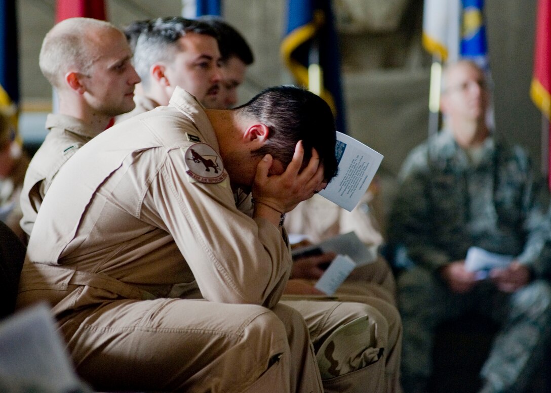 An Airman mourns during a memorial service May 9, 2013, at Transit Center at Manas, Kyrgyzstan. Service members gathered to honor Capt. Mark "Tyler" Voss, Capt. Victoria "Tori" Pinckney, and Tech. Sgt. Herman "Tre" Mackey III after their aircraft crashed May 3, 2013, in northern Kyrgyzstan. (U.S. Air Force photo/Staff Sgt. Stephanie Rubi)