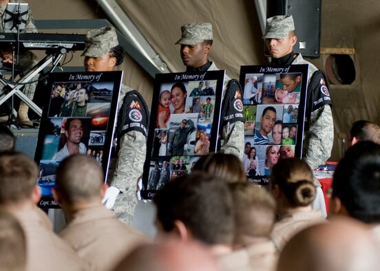 Members from the 376th Air Expeditionary Wing Honor Guard team carry photos of fallen crew members of Shell 77 during a memorial service held in their honor May 9, 2013, at Transit Center at Manas, Kyrgyzstan. The three crew members perished May 3, 2013, when their KC-135 Stratotanker crashed in northern Kyrgyzstan. All three were deployed to the 376th AEW's 22nd Expeditionary Air Refueling Squadron from Fairchild Air Force Base, Wash., in support of Operation Enduring Freedom. (U.S. Air Force photo/Staff Sgt. Stephanie Rubi)