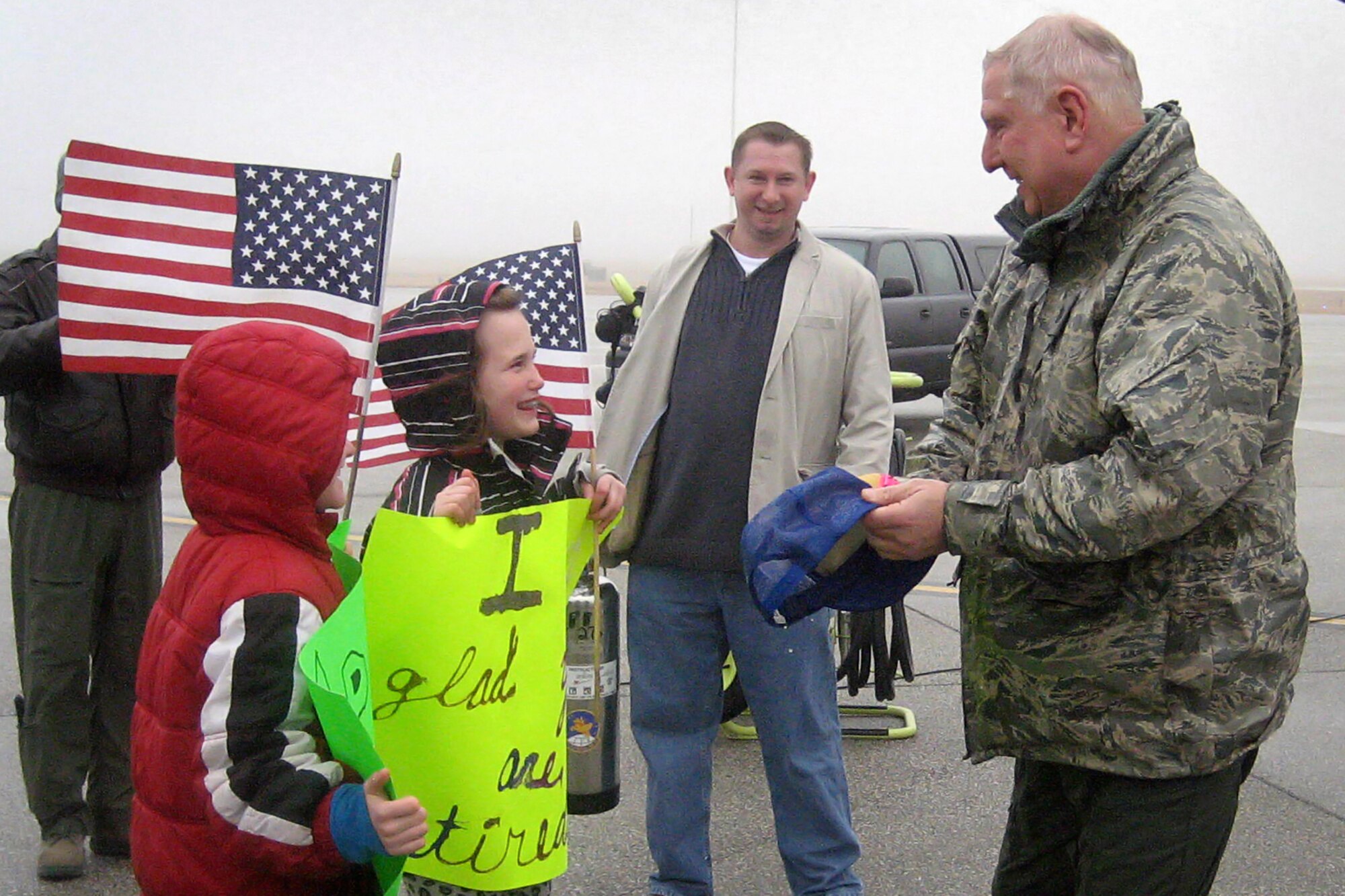GRISSOM AIR RESERVE BASE, Ind. -- Lt. Col. Don Windt Windt, 74th Air Refueling Squadron pilot, is greeted by his grandchildren Sam and Annalise Bowldy, and his son Brendan Windt after his final flight with a KC-135R Stratotanker here March 18. Windt retired March 24 with approximately 36-and-one-half years of military service. (U.S. Air Force Photo/Sonya Brown) 
