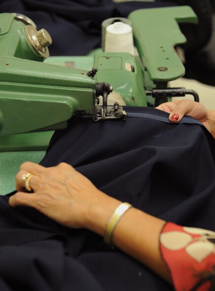 Tam Harper, Army & Air Force Exchange Service alterations seamstress, hems mess dress skirt on Barksdale Air Force Base, La., May 8, 2013. The seamstresses at the AAFES alterations shop are well-versed in Air Force and Army uniform dress and appearance and ensure service members' uniforms are in regulation. (U.S. Air Force photo/Airman 1st Class Benjamin Gonsier)
