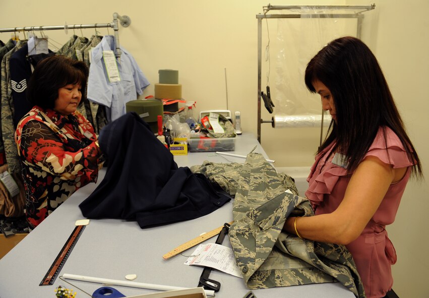 Tam Harper, left, and Jantip Sangpron, Army & Air Force Exchange Service alterations seamstresses, prepare uniforms for alterations on Barksdale Air Force Base, La., May 8, 2013. The AAFES Cleaners and Alterations shops are open Monday to Friday from 8:00 a.m. to 6:00 p.m., Saturday from 9:00 a.m to 4:00 p.m. and are closed every Sunday and on holidays. (U.S. Air Force photo/Airman 1st Class Benjamin Gonsier)