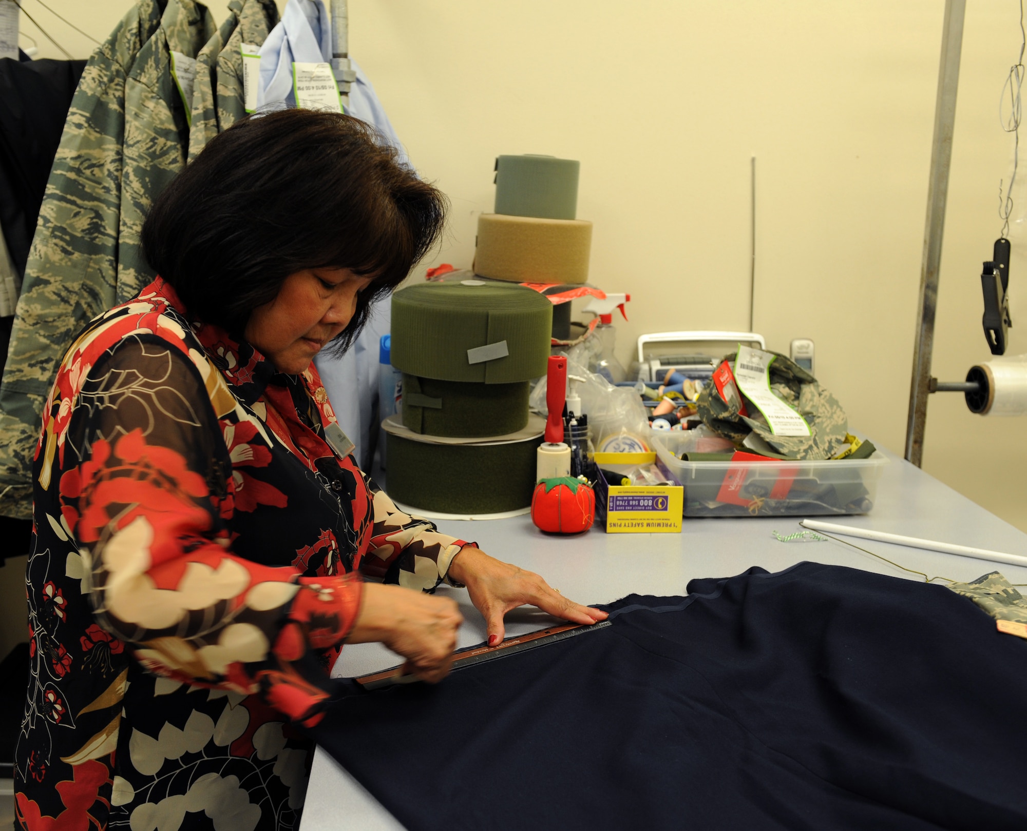 Tam Harper, Army & Air Force Exchange Service alterations seamstress, marks where a mess dress skirt needs to be hemmed on Barksdale Air Force Base, La., May 8, 2013. The seamstresses at the AAFES alterations shop are well-versed in Air Force and Army uniform dress and appearance and ensure service members' uniforms are in regulation. (U.S. Air Force photo/Airman 1st Class Benjamin Gonsier)
