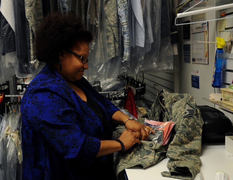 Brenda Dukes, Army & Air Force Exchange Service cleaners, inserts Senior Master Sergeant stripes into an ABU pocket on Barksdale Air Force Base, La., May 8, 2013. The AAFES Cleaners gives members of Team Barksdale convenient on-base dry cleaning services. (U.S. Air Force photo/Airman 1st Class Benjamin Gonsier)