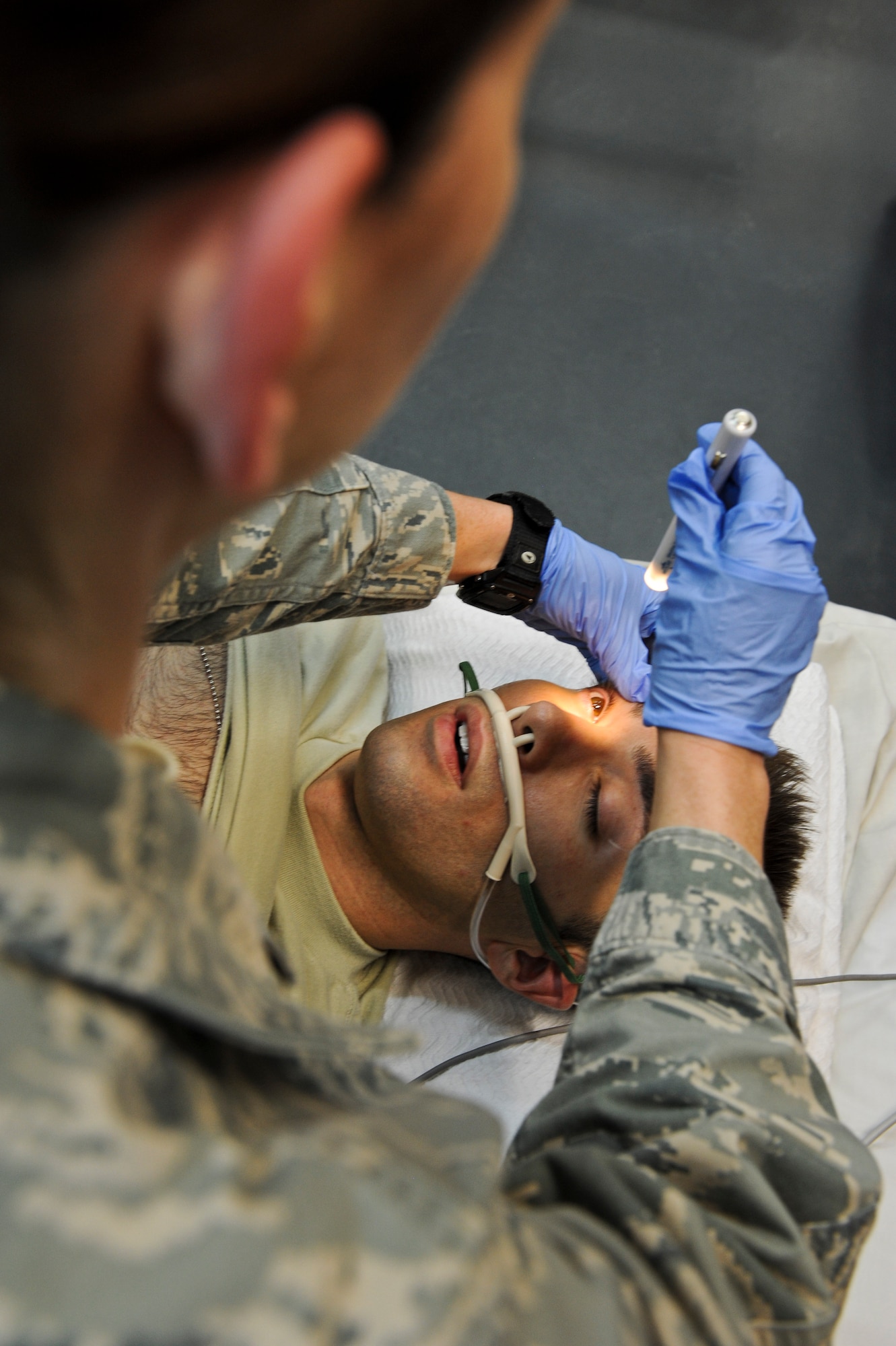 Tech. Sgt. Courtney Leahy practices checking the vitals of mock patient, Senior Airman Jason Henderson, May 9, 2013, at the 379th Air Expeditionary Wing’s medical facility. Leahy and Henderson are 379th Expeditionary Medical Operations Squadron medical technicians and deployed here from Joint Base Langley-Eustis, Va. The Air Force Medical Service celebrates Nurse and Medical Technician week May 6 - 12. This year's event is themed delivering quality and innovation in patient care. (U.S. Air Force photo/Senior Airman Benjamin Stratton)