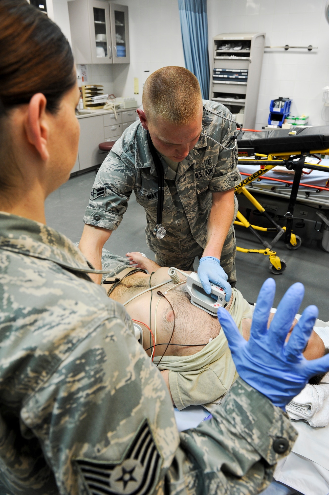 Tech. Sgt. Courtney Leahy watches as Airman 1st Class Joshua May practices using a defibrillator on a mock patient, May 9, 2013, at the 379th Air Expeditionary Wing’s medical facility. Leahy and May are 379th Expeditionary Medical Operations Squadron medical technicians and deployed here from Joint Base Langley-Eustis, Va. The Air Force Medical Service celebrates Nurse and Medical Technician week May 6 - 12. (U.S. Air Force photo/Senior Airman Benjamin Stratton)