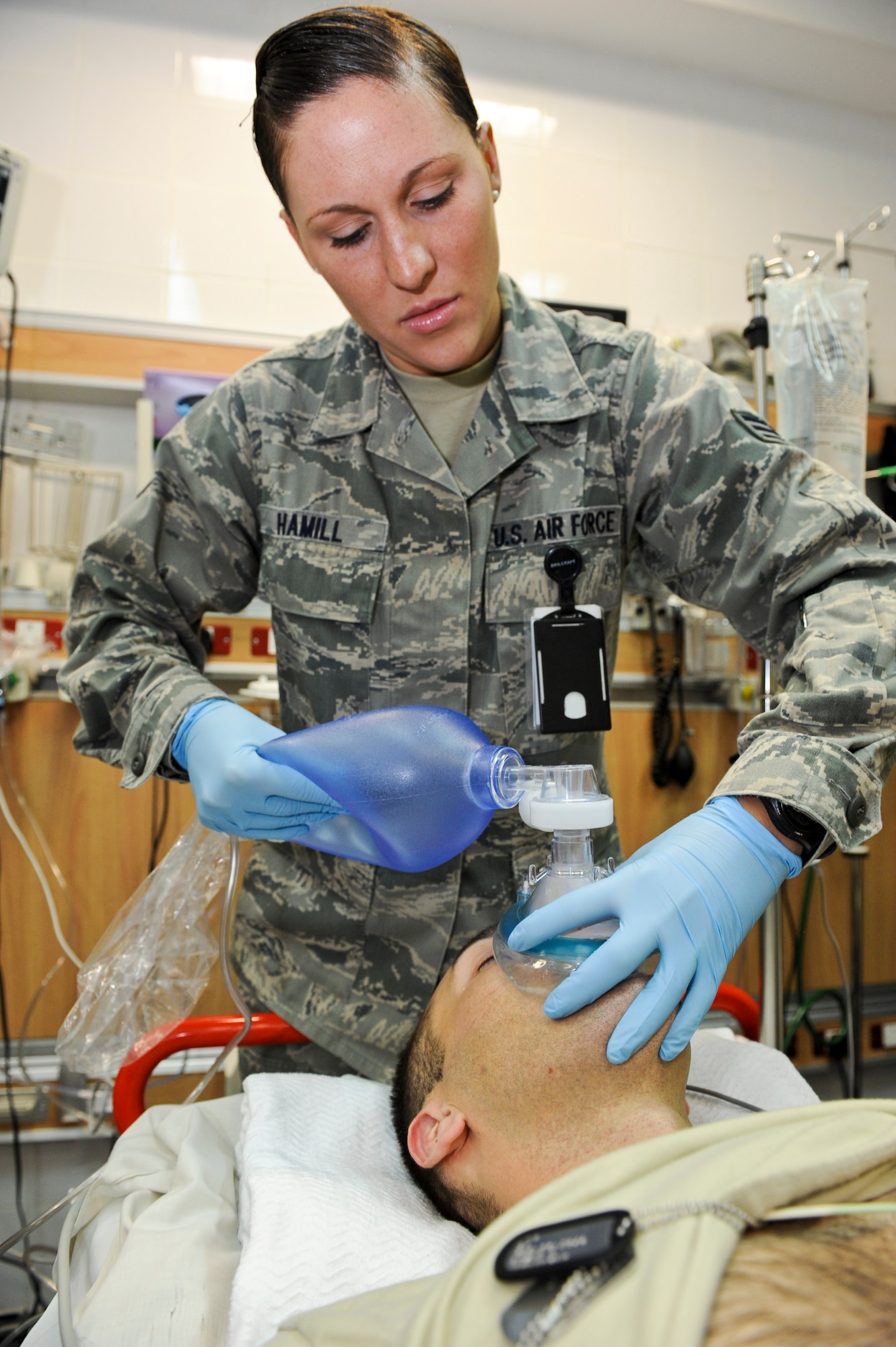 Senior Airman Sonni Hamill ensures mock patient, Senior Airman Jason Henderson, receives the necessary oxygen for survival, May 9, 2013, at the 379th Air Expeditionary Wing’s medical facility. Henderson and Hamill are 379th Expeditionary Medical Operations Squadron medical technicians and deployed here from Joint Base Langley-Eustis, Va. The Air Force Medical Service celebrates Nurse and Medical Technician week May 6 - 12. Nurses and medical technicians — Active Duty, Reserve, Guard, civilians and contractors — support U.S. servicemen and women across the globe. (U.S. Air Force photo/Senior Airman Benjamin Stratton)