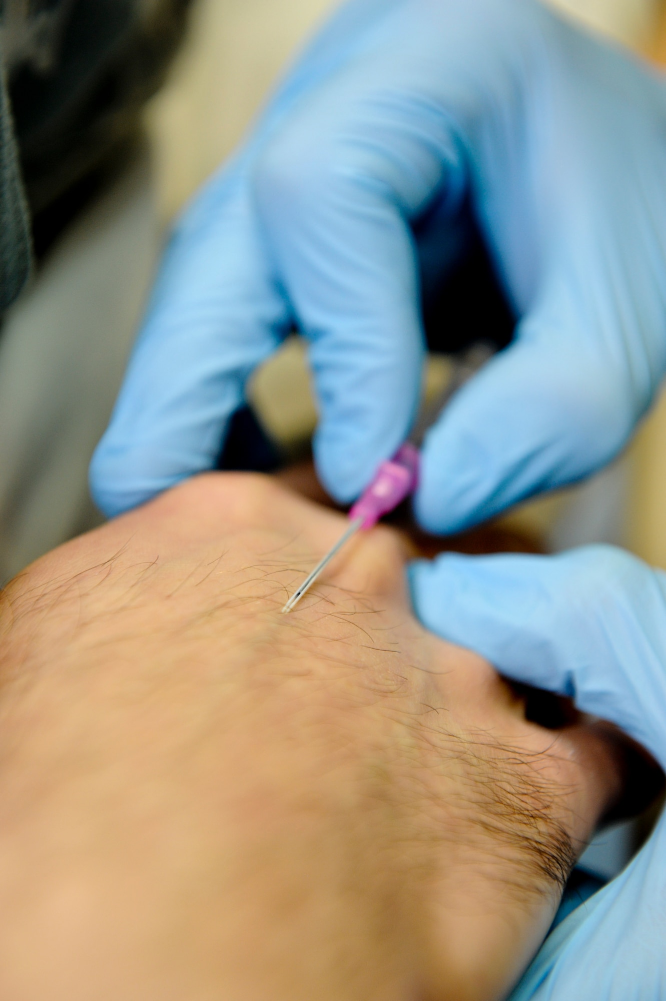 A 379th Expeditionary Medical Operations Squadron medical technician practices inserting an IV needle into a mock patient’s vein, May 9, 2013, at the 379th Air Expeditionary Wing’s medical facility. The Air Force Medical Service celebrates Nurse and Medical Technician week May 6 - 12. This year's event is themed delivering quality and innovation in patient care. (U.S. Air Force photo/Senior Airman Benjamin Stratton)