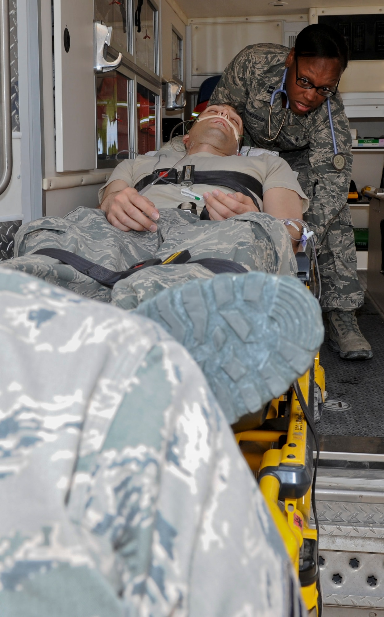 Capt. Natasha Sommerville, 379th Expeditionary Medical Operations Squadron nurse, practices responding to mock patient, Senior Airman Jason Henderson, 379th EMDOS medical technician, in an ambulance, May 9, 2013, at the 379th Air Expeditionary Wing’s medical facility. Sommerville and Henderson deployed here from Joint Base Langley-Eustis, Va. The Air Force Medical Service is celebrating Nurse and Medical Technician week May 6 - 12. (U.S. Air Force photo/Senior Airman Benjamin Stratton)