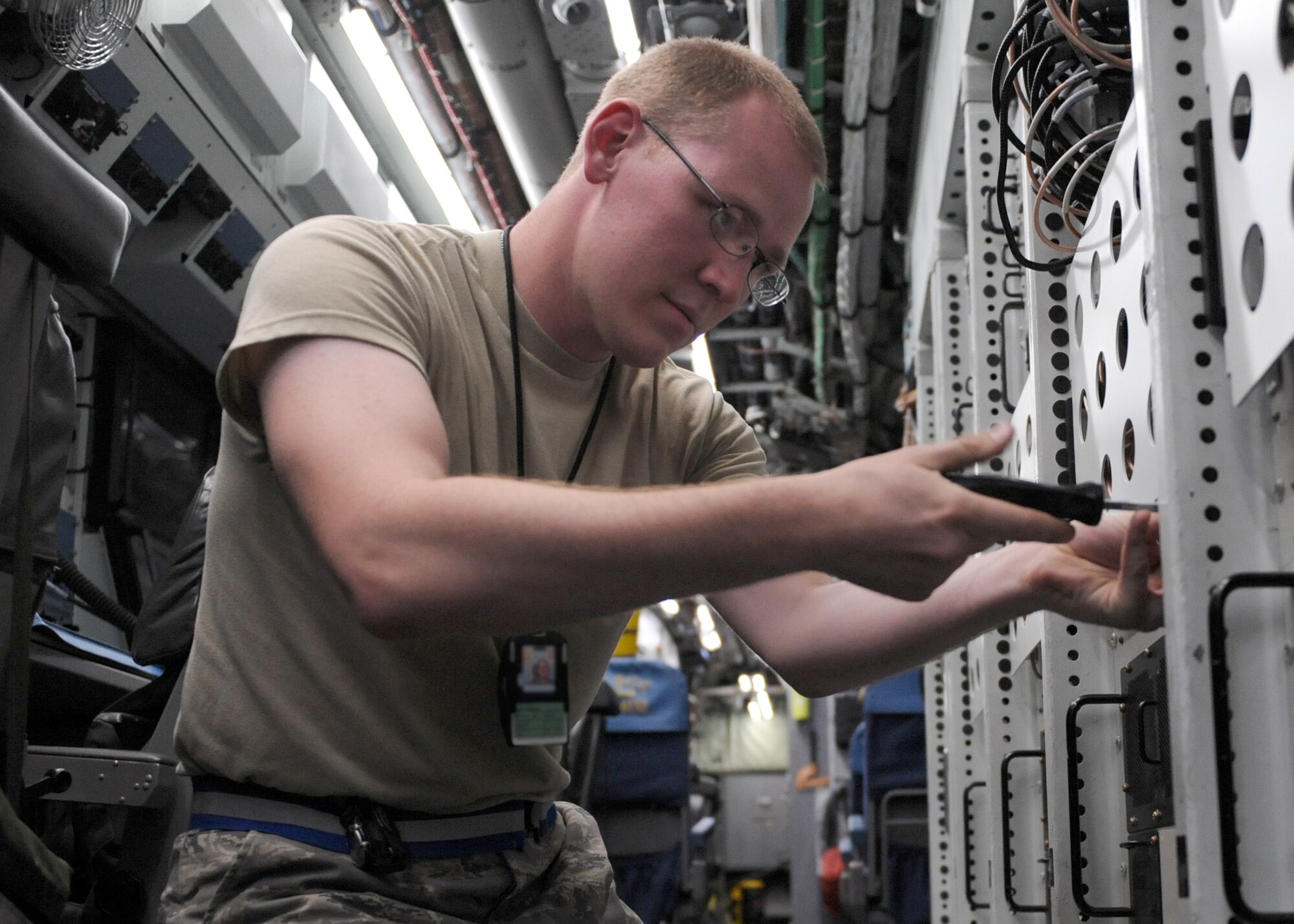 SOUTHWEST ASIA -- Senior Airman Ross Lemp, a 763rd Expeditionary Reconnaissance Squadron electronic warfare maintainer, performs routine maintenance onboard a RC-135V/W Rivet Joint May 6, 2013, at the 379th Air Expeditionary Wing. The RC-135’s are primarily used as an intelligence, surveillance and reconnaissance platform; picking up real-time information on oppositional forces. Toy and Lemp are deployed from Offutt Air Force Base, Neb. (U.S. Air Force photo/Staff Sgt. Joel Mease)