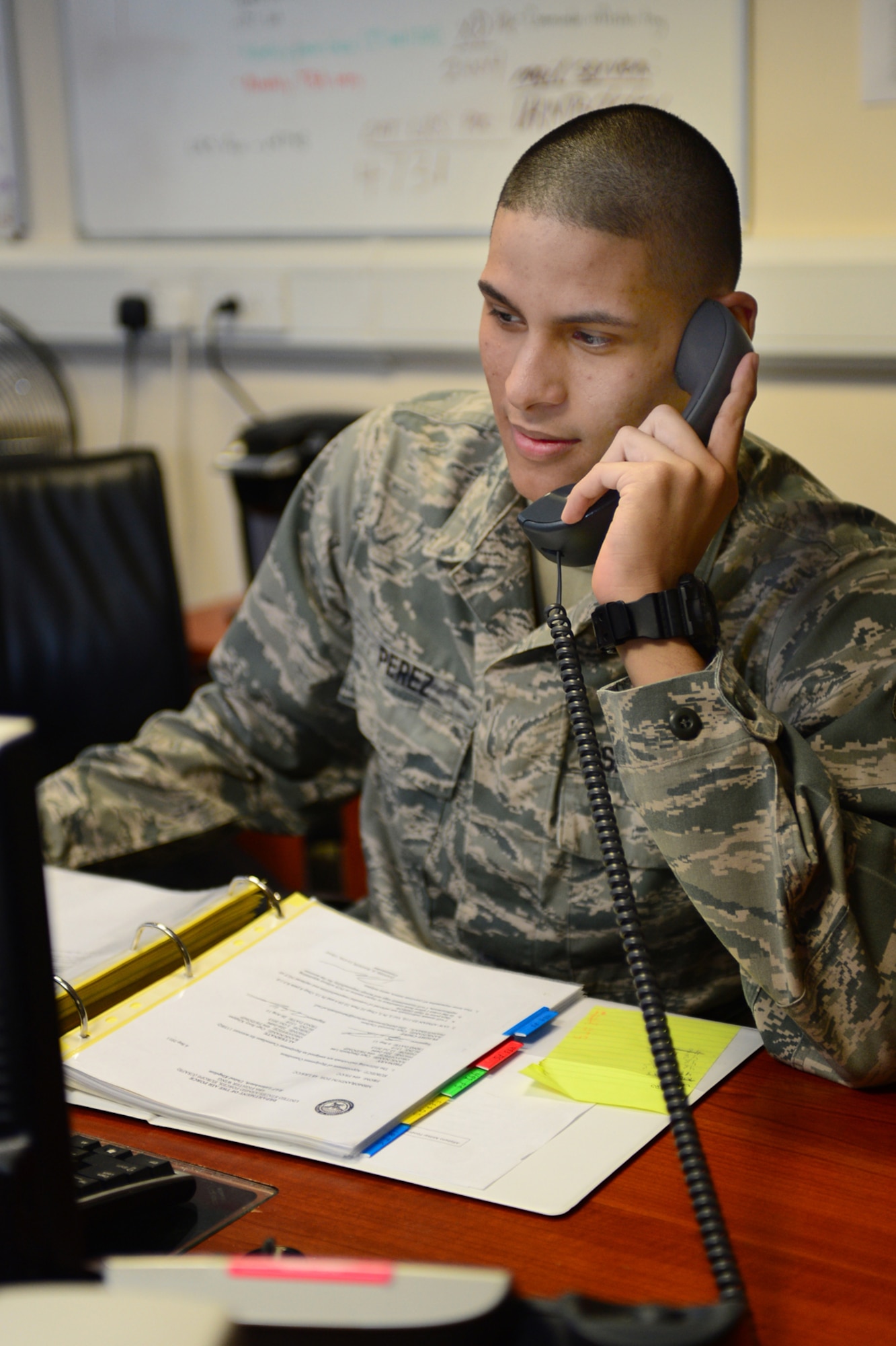ROYAL AIR FORCE LAKENHEATH, England -- Airman 1st Class Xavier Perez, 48th Logistics Readiness Squadron logistics planner, verifies a tasking over the phone with a unit deployment manager at the installation deployment readiness center May 7, 2013. Perez was nominated for a Liberty Spotlight because he displays the core value of "Excellence in All We Do." (U.S. Air Force photo by Airman 1st Class Dana J. Butler)