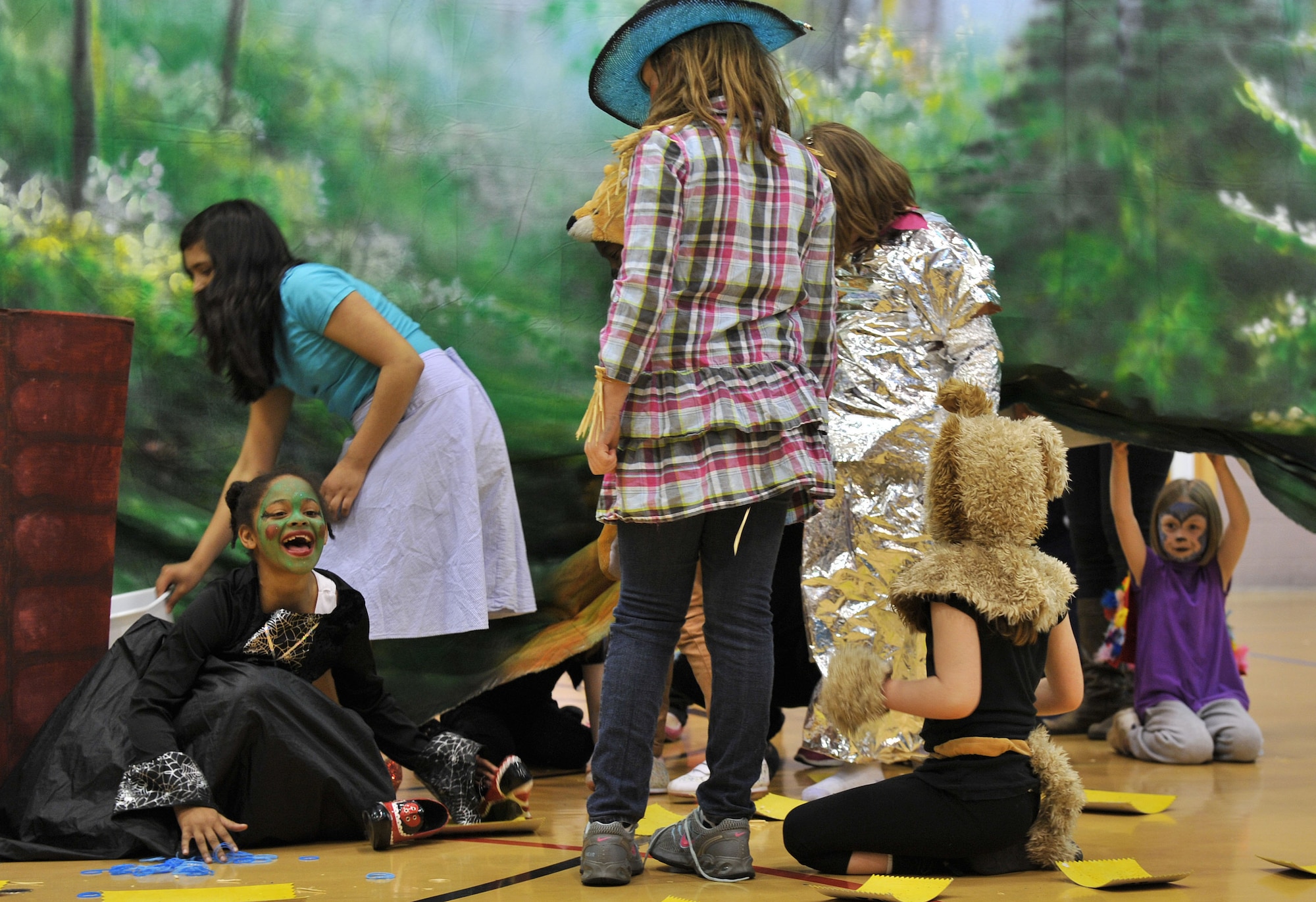 From left, the Wicked Witch, played by Arianna Matthew, begins to melt after Dorothy, played by Gloryssel Moreno, throws a bucket of “water” on her during the production of the “Wizard of Oz” May 7, 2013, at the youth center on RAF Mildenhall, England. The youth center routinely showcases the children’s talents through events including plays and fun days, as well as broadens their minds with educational field trips. (U.S. Air Force photo by Tech. Sgt. Stacia Zachary/Released)