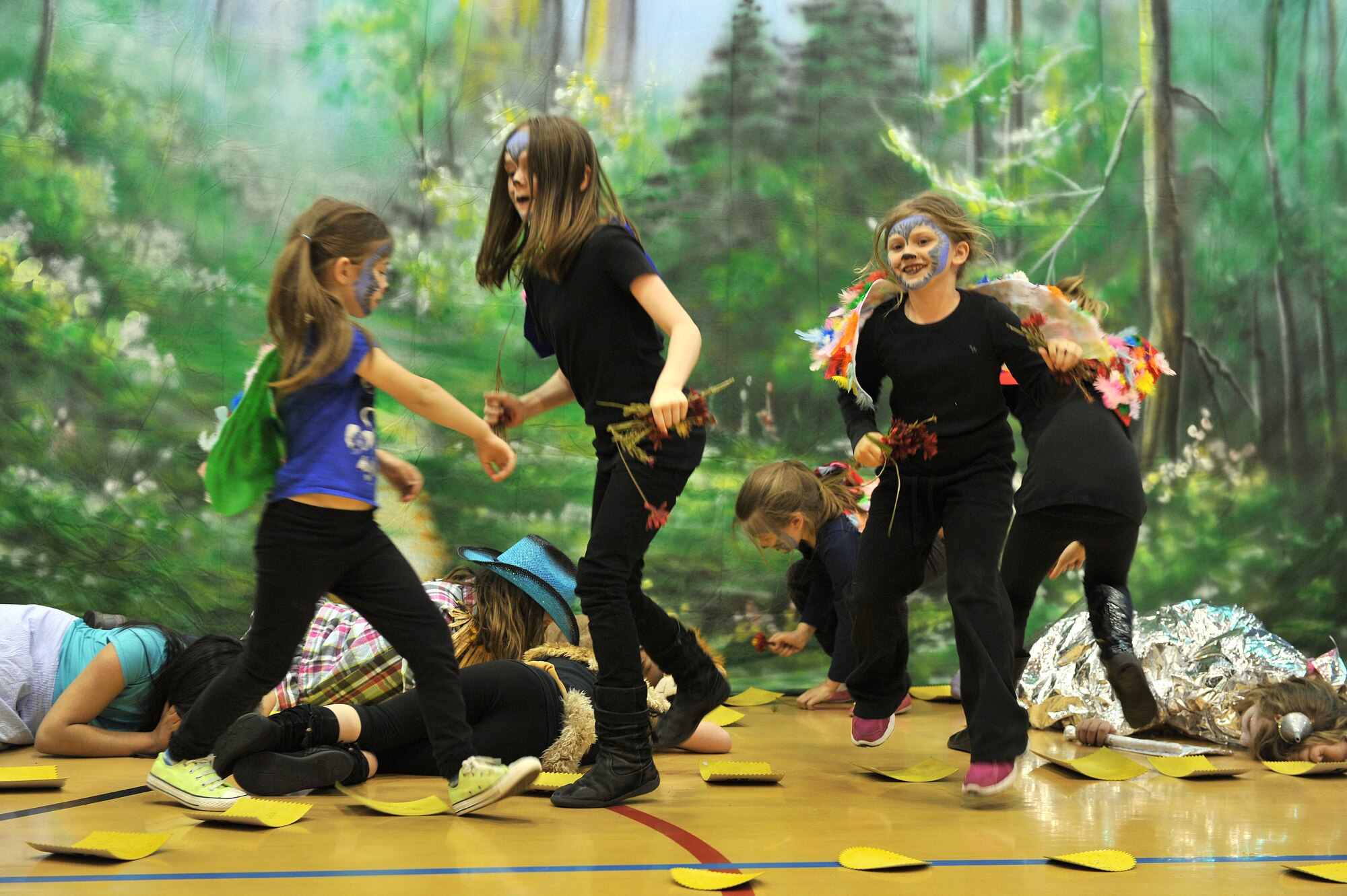 Flying monkeys swoop in and take items from sleeping Dorothy, Toto the Dog, the Cowardly Lion, the Scarecrow and the Tin Man during the production of the “Wizard of Oz” May 7, 2013, at the youth center on RAF Mildenhall, England. The youth center routinely showcases the children’s talents through events including plays and fun days, as well as broadens their minds with educational field trips. (U.S. Air Force photo by Tech. Sgt. Stacia Zachary/Released)