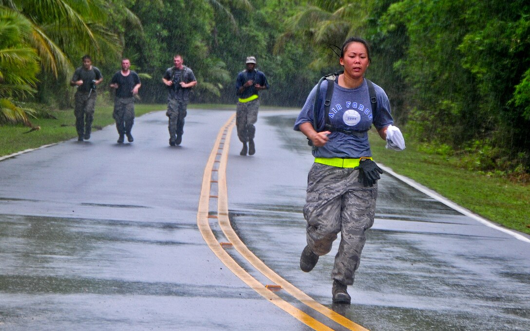 Tech. Sgt. Brina Cervantes, 36th Mobility Response Squadron Supply Management NCO in charge, leads the run toward the finish line during a 36th MRS training day at Andersen Air Force Base, Guam, May 2, 2013. Members of the 36th MRS were required to complete a four-and-a-half mile course with seven different challenge station designed to promote team building, physical fitness and squadron morale. (U.S. Air Force photo by Airman 1st Class Marianique Santos/Released)