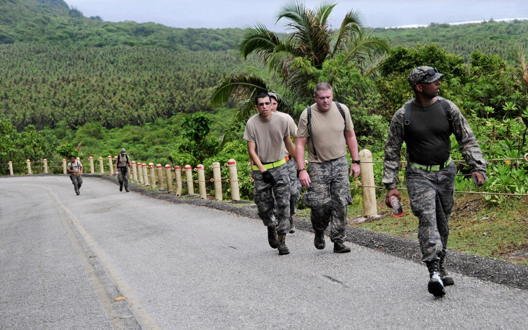 Members from the 36th Mobility Response Squadron hike to the top of Sanders Slope to set up a simulated marker beacon during a 36th MRS training day on Andersen Air Force Base, Guam, May 2, 2013. Members of the 36th MRS were required to complete a 4.5 mile course with seven different challenge station designed to promote team building, physical fitness and squadron morale. (U.S. Air Force photo by Airman 1st Class Marianique Santos/Released)