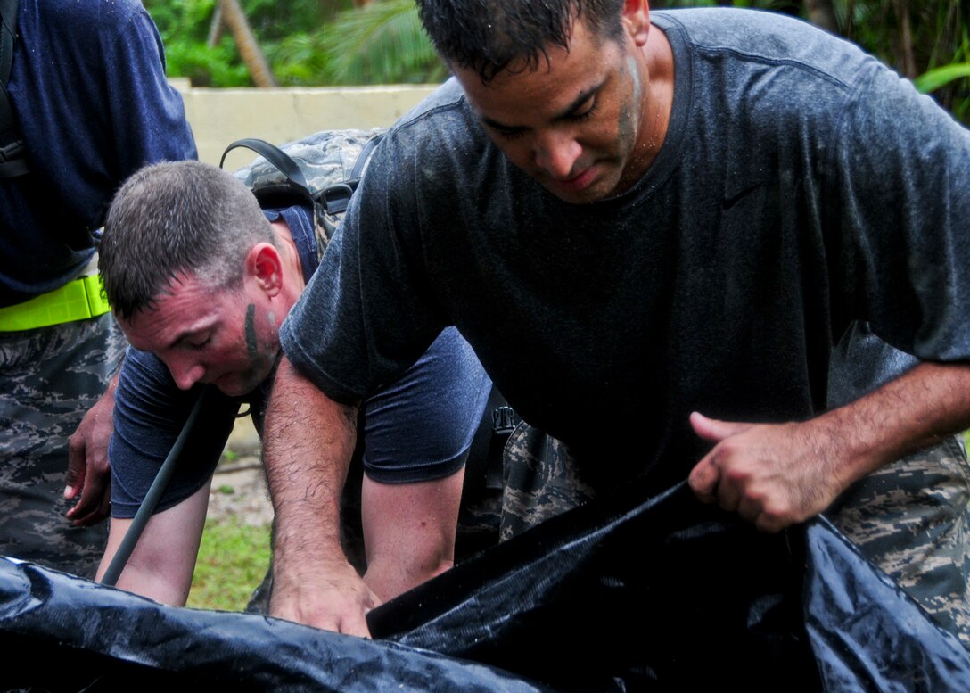 Members from the 36th Mobility Response Squadron pack up a tent after completing a challenge during a 36th MRS training day at Andersen Air Force Base, Guam, May 2, 2013. In accomplishing these tasks, 36th MRS members demonstrated their proficiency at organizing, equipping and leading cross-functional forces as the initial Air Force presence at forward operating locations across the Pacific area of responsibility. (U.S. Air Force photo by Airman 1st Class Marianique Santos/Released)