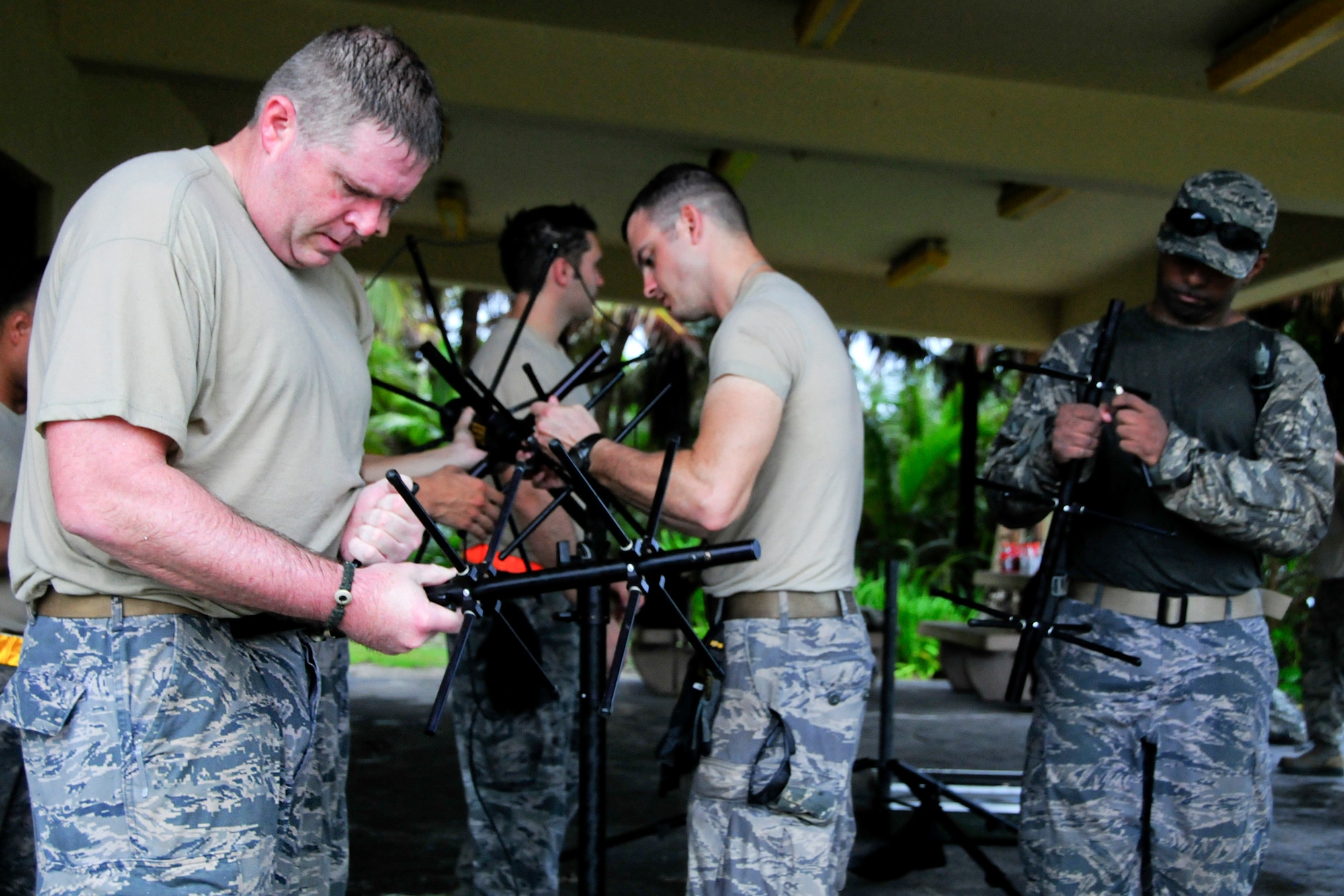 Members from 36th Mobility Response Squadron work together to dismantle a demand assigned multiple access satellite-communications device after completing the challenge of building it during a 36th MRS training day on Andersen Air Force Base, Guam, May 2, 2013. In accomplishing these tasks, 36th MRS members demonstrated their proficiency at organizing, equipping and leading cross-functional forces as the initial Air Force presence at forward operating locations across the Pacific area of responsibility. (U.S. Air Force photo by Airman 1st Class Marianique Santos/Released)