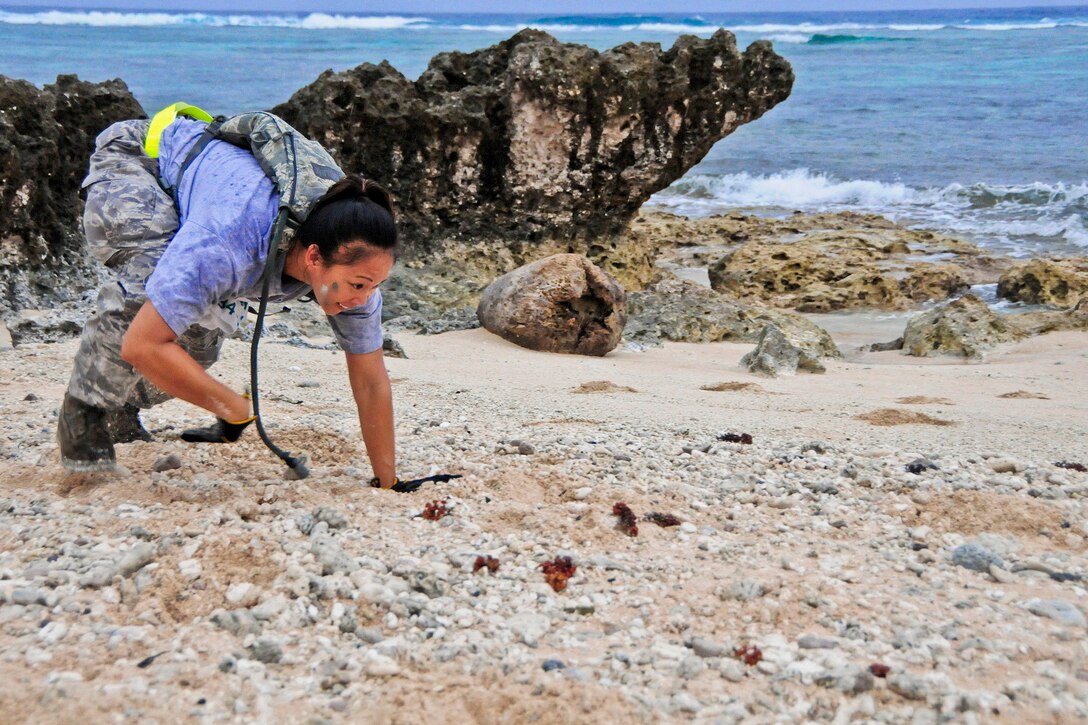 Tech. Sgt. Brina Cervantes, 36th Mobility Response Squadron Supply Management NCO in charge, bear crawls during a 36th MRS training day on Andersen Air Force Base, Guam, May 2, 2013. Members of the 36th MRS were required to complete a four-and-a-half mile course with seven different challenge station designed to promote team building, physical fitness and squadron morale. (U.S. Air Force photo by Airman 1st Class Marianique Santos/Released)
