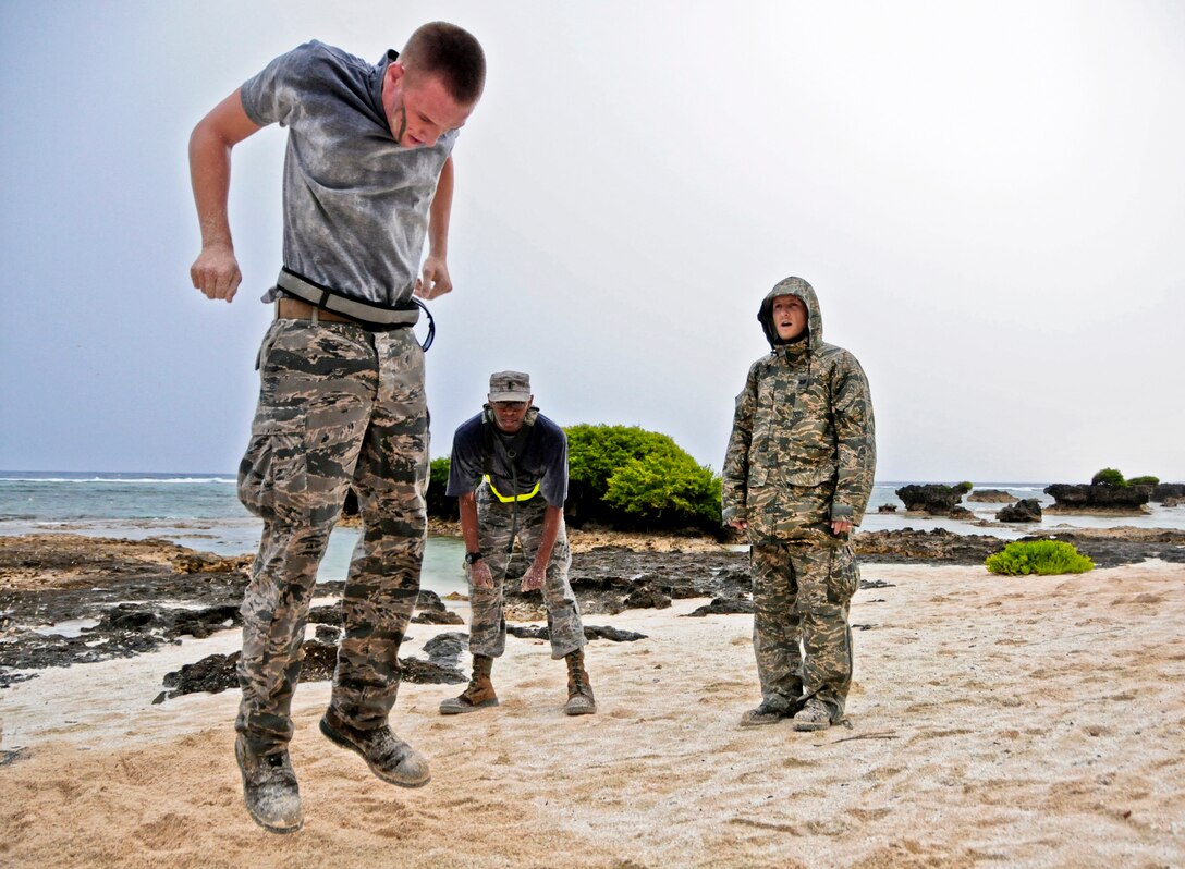 Senior Airman Christopher Follet, 36th Mobility Response Squadron Air T¬¬ransportation specialist, performs callisthenic exercises while other Airmen track his progress during a 36th MRS training day on Andersen Air Force Base, Guam, May 2, 2013. Each 36th MRS member faced challenges designed to test physical fitness, individual and team decision-making skills during the rescue scenario. (U.S. Air Force photo by Airman 1st Class Marianique Santos/Released)
