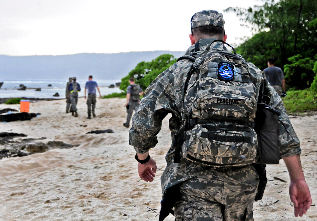 Lt. Col. Bill Percival, 36th Mobility Response Squadron commander, meets training day participants at  the first hydration station during a 36th MRS training day on Andersen Air Force Base, Guam, May 2, 2013. Members of the 36th MRS were required to complete a four -and-a-half mile course with seven different challenge stations designed to promote team building, physical fitness and squadron morale. (U.S. Air Force photo by Airman 1st Class Marianique Santos/Released)