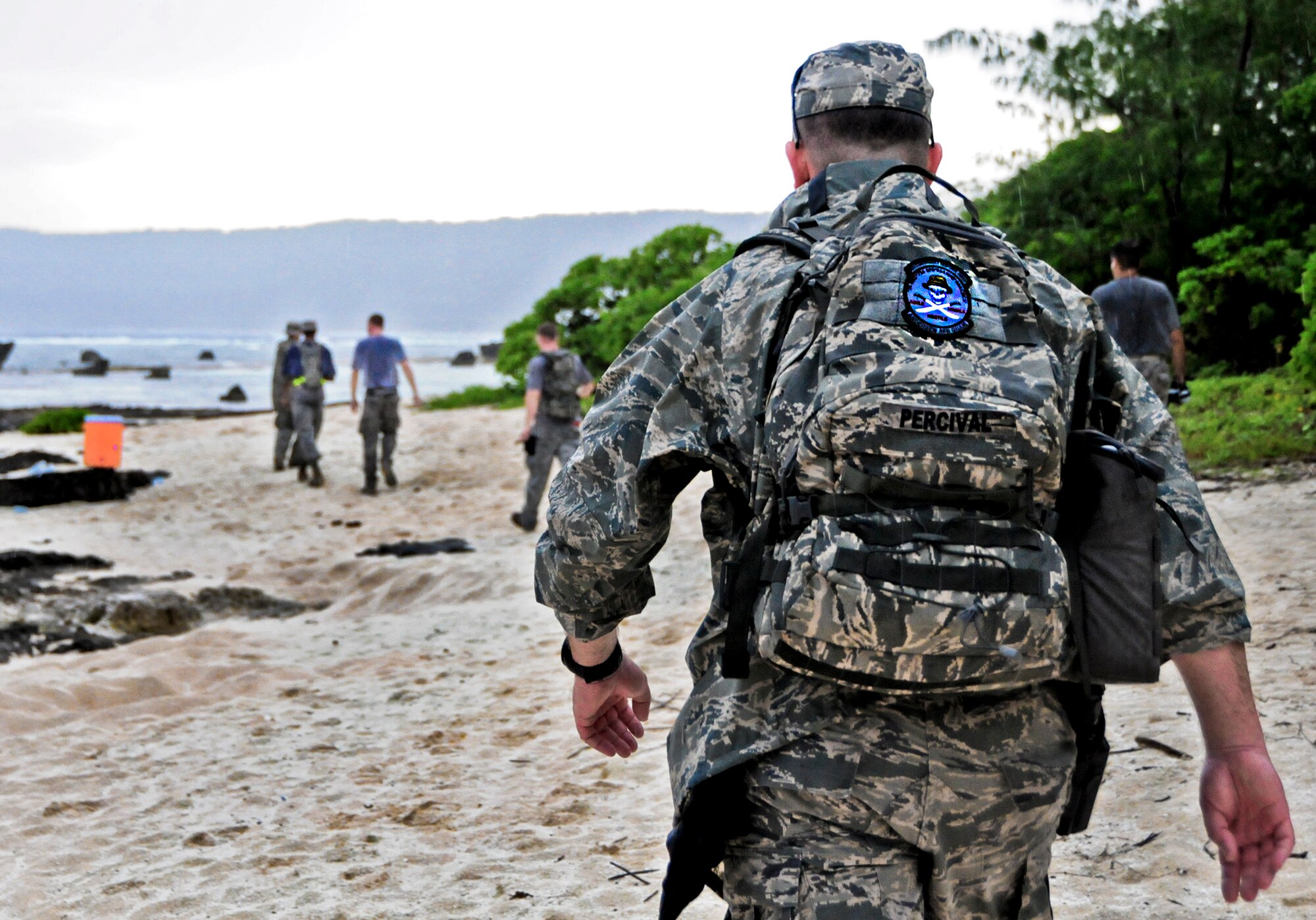 Lt. Col. Bill Percival, 36th Mobility Response Squadron commander, meets training day participants at  the first hydration station during a 36th MRS training day on Andersen Air Force Base, Guam, May 2, 2013. Members of the 36th MRS were required to complete a four -and-a-half mile course with seven different challenge stations designed to promote team building, physical fitness and squadron morale. (U.S. Air Force photo by Airman 1st Class Marianique Santos/Released)