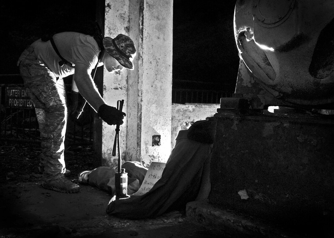 Master Sgt. Jason Neighbors, 36th Mobility Response Squadron Contingency Engineering NCO in charge, discovers the location of “Sergeant Castro” during a 36th MRS training day on Andersen Air Force Base, Guam, May 2, 2013. Through a simulated rescue mission, members of the 36th MRS tested their endurance, teamwork and on-the-job knowledge. (U.S. Air Force photo by Airman 1st Class Marianique Santos/Released)
