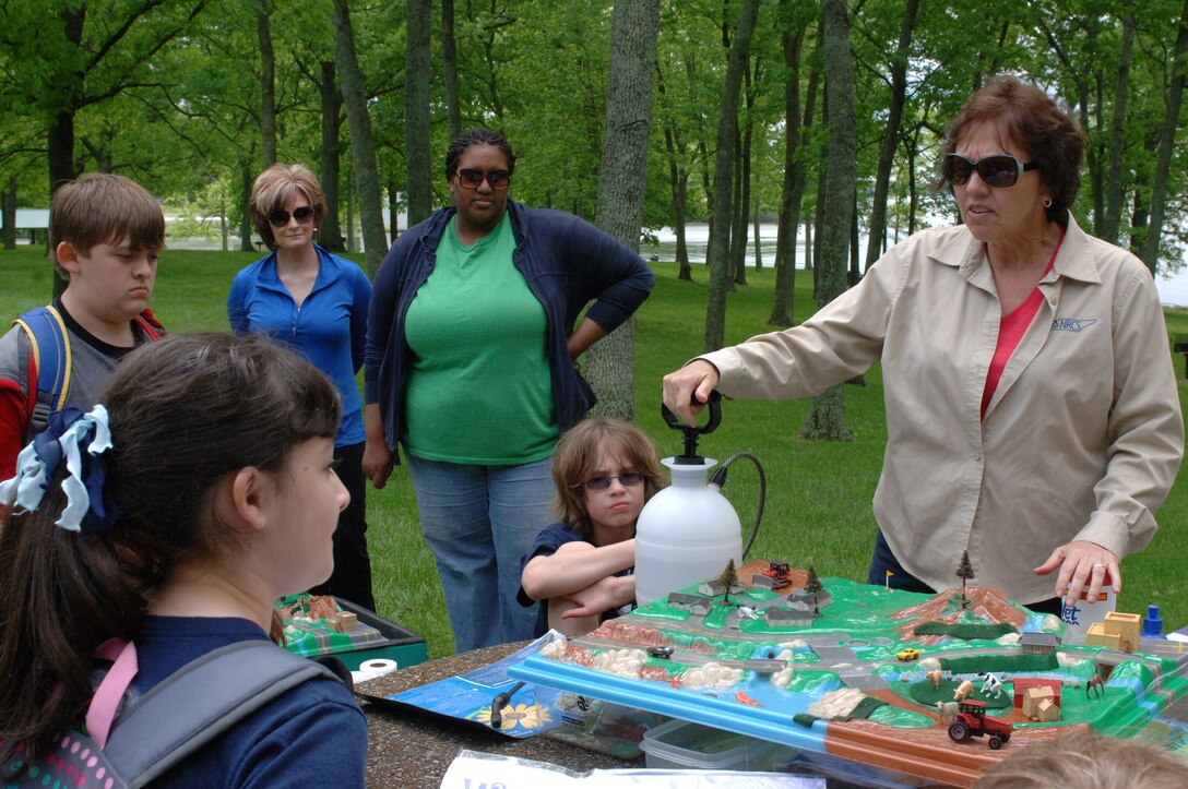 Carolyn Dillard, a conservationist with the National Resources Conservation Service, uses a model to explain how pesticides and fertilizers and other contaminants are washed into watersheds and the importance of protecting the environment to students from Hawkins Middle School.  This is one of 11 learning stations the kids rotated between on Environmental Awareness Day on the shoreline of Old Hickory Lake May 2, 2013.  The event took place at Rockland Recreation Area in Hendersonville, Tenn.