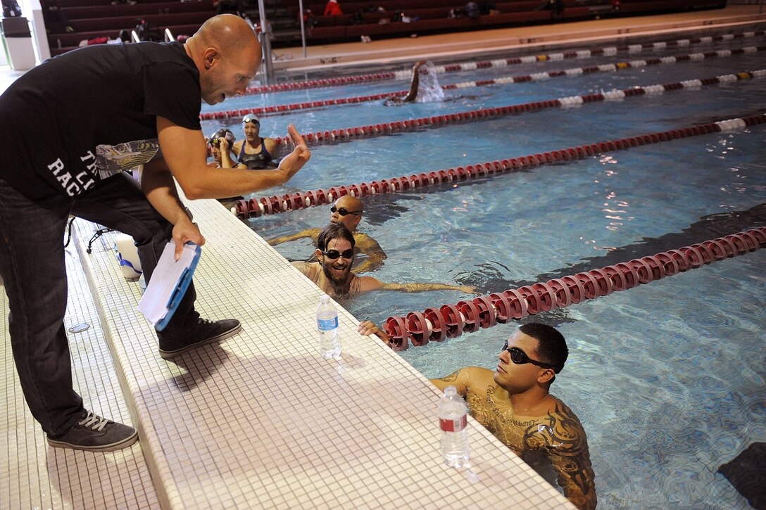 Swim coach Michael Kleinert instructs the Marines Corps Wounded Warrior Regiment swim team as they practice in Colorado Springs, Colo., April 29, 2013.