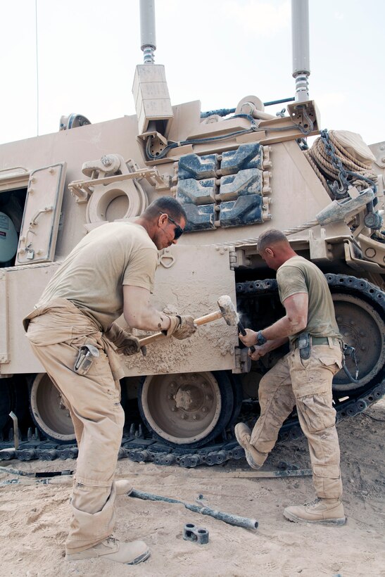 U.S. Marine Corps Anthony Andress, left, and Sgt. Christopher Cannella, right, conduct routine maintenance on a M88A2 Hercules recovery vehicle on Forward Operating Base Shir Ghazay, Helmand province, Afghanistan, May 7, 2013. 