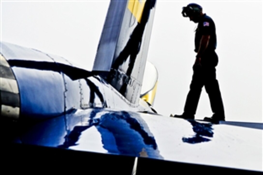 Navy Petty Officer 1st Class Benjamin Liskey inspects an F/A-18 Hornet before a flight during morning operations in Pensacola, Fla., May 8, 2013. Liskey is assigned to the Blue Angels, the Navy's flight demonstration squadron.