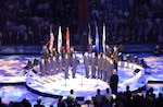 NORAD – USNORTHCOM joint service color guard lines up behind members of the Air Force Academy choir during the opening ceremony of the NBA All-Star game Sunday in Denver. Color guard members are, left to right, Army Sgt. Leander Jones III, Sgt. 1st Class Martin Thomas, Spc. Charles Kemp, Marine Corps Staff Sgt. Kenneth Edwards, Navy Petty Officer 2nd Class David Diener, Air Force Staff Sgt. Tameshia Johnson, Coast Guard Petty Officer 1st Class Chris Meedel and Marine Corps Sgt. Grayson Warbritton.