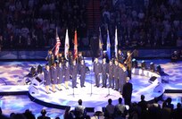 NORAD – USNORTHCOM joint service color guard lines up behind members of the Air Force Academy choir during the opening ceremony of the NBA All-Star game Sunday in Denver. Color guard members are, left to right, Army Sgt. Leander Jones III, Sgt. 1st Class Martin Thomas, Spc. Charles Kemp, Marine Corps Staff Sgt. Kenneth Edwards, Navy Petty Officer 2nd Class David Diener, Air Force Staff Sgt. Tameshia Johnson, Coast Guard Petty Officer 1st Class Chris Meedel and Marine Corps Sgt. Grayson Warbritton.