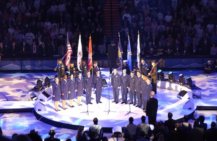 NORAD – USNORTHCOM joint service color guard lines up behind members of the Air Force Academy choir during the opening ceremony of the NBA All-Star game Sunday in Denver. Color guard members are, left to right, Army Sgt. Leander Jones III, Sgt. 1st Class Martin Thomas, Spc. Charles Kemp, Marine Corps Staff Sgt. Kenneth Edwards, Navy Petty Officer 2nd Class David Diener, Air Force Staff Sgt. Tameshia Johnson, Coast Guard Petty Officer 1st Class Chris Meedel and Marine Corps Sgt. Grayson Warbritton.