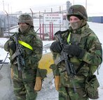 U.S. Army Specialists Brad Fraser (left) and Daniel McKinlay stand guard at the Port of Anchorage Wednesday morning as part of Exercise Vigilant Port. Over 200 soldiers, Coast Guardsmen and state and local officials are participating in the two day operation that is being run by Joint Task Force Alaska. Vigilant Port's scenario includes a terrorist threat targeting military equipment being shipped via the port. The Port of Anchorage is one of 15 US strategic seaports and approximately 90 percent of all consumer goods in Alaska flow through the port.  The exercise is set to  end late Wednesday afternoon.