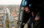 NEW ORLEANS - Coast Guard Petty Officer 2nd Class Shawn Beaty, 29, of Long Island, N.Y., looks for survivors in the wake of Hurricane Katrina Aug. 30.  Beaty is a member of an HH-60 Jayhawk helicopter rescue crew sent from Clearwater, Fla., to assist in search and rescue efforts.  U.S. Coast Guard photograph by Petty Officer 2nd Class NyxoLyno Cangemi