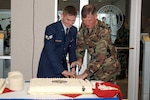 USNORTHCOM Deputy Commander Army Lt. Gen. Joseph Inge and Air Force Senior Airman Andrew Roberts, 22, the youngest military member assigned to the command, cut the ceremonial caked during the command’s third anniversary celebration Sept. 30. 