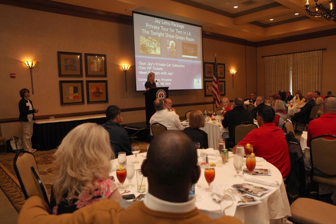 Brianna Keilar, the master of ceremonies and CNN White House correspondent, auctions off prizes at the 10th Anniversary Fisher House Golf Classic at The Golf Club at Lansdowne, Va., on May 6, 2013. (U.S. Marine Corps photo by Sgt. Marionne T. Mangrum)