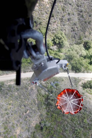 A Bambi Bucket, also known as a fire bucket, is attached to a CH-46E transporting water during the 6th annual aerial wildland fire fighting exercise here May 9.  