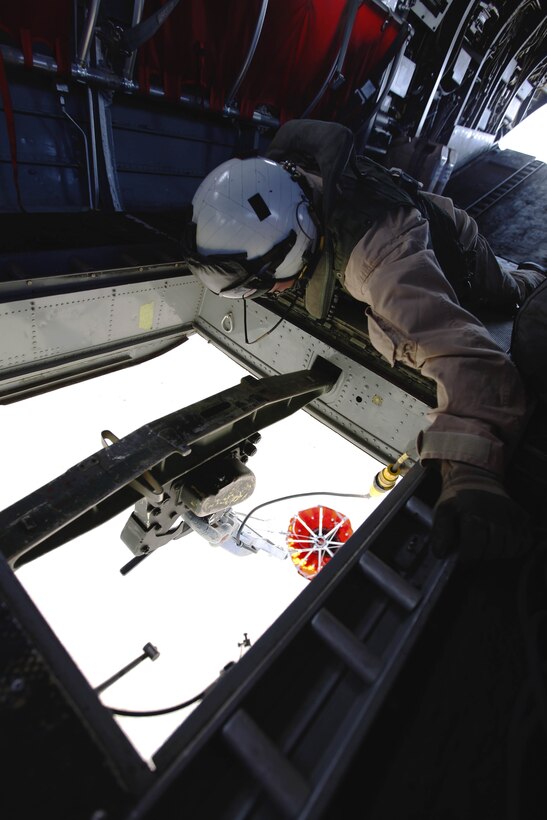 Staff Sgt. Brian Dinning monitors the firebucket as it fills with water during the 6th annual aerial wildland fire fighting exercise here May 9. Dinning is a crew chief with Marine Medium Helicopter Training Squadron-164 with the air station here.