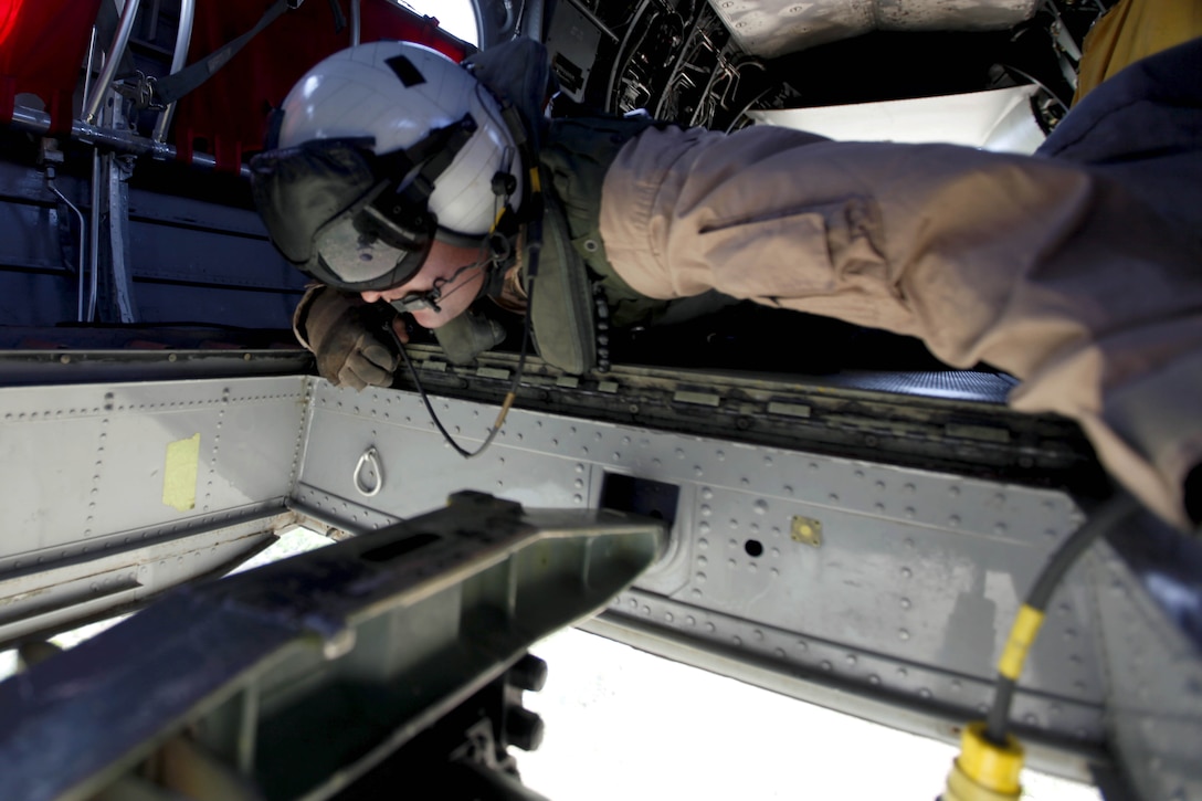 Staff Sgt. Brian Dinning monitors the firebucket as it fills with water during the 6th annual aerial Wild Land Fire Fighting exercise here May 9. Dinning is a crew chief with Marine Medium Helicopter Training Squadron-164 with the air station here.