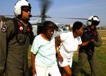 Navy Search and Rescue team members, deployed to New Orleans in September 2005 in the U.S. Northern Command-led Joint Task Force - Katrina, help Hurricane Katrina victims to an evacuation center. USNORTHCOM's two-fold mission includes defending the homeland and providing support to civil authorities. 
