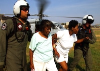 Navy Search and Rescue team members, deployed to New Orleans in September 2005 in the U.S. Northern Command-led Joint Task Force - Katrina, help Hurricane Katrina victims to an evacuation center. USNORTHCOM's two-fold mission includes defending the homeland and providing support to civil authorities. 