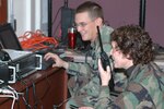 Col. Babette Lenfant works with Staff Sgt. Ethan Mabry during the Defense Interoperability Communications Exercise 06 to test a system that can tie together several different types of communications systems. DICE06 took place at Joint Task Force Civil Support Headquarters on Fort Monroe, Va. 