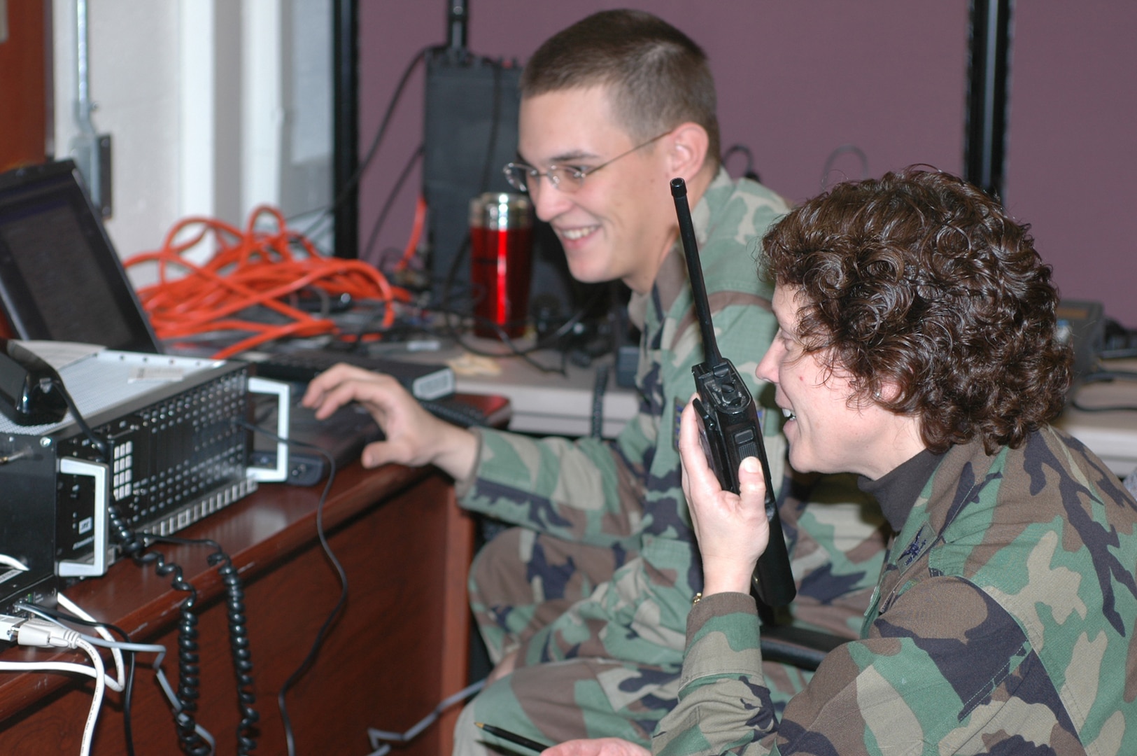 Col. Babette Lenfant works with Staff Sgt. Ethan Mabry during the Defense Interoperability Communications Exercise 06 to test a system that can tie together several different types of communications systems. DICE06 took place at Joint Task Force Civil Support Headquarters on Fort Monroe, Va. 