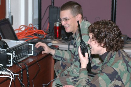 Col. Babette Lenfant works with Staff Sgt. Ethan Mabry during the Defense Interoperability Communications Exercise 06 to test a system that can tie together several different types of communications systems. DICE06 took place at Joint Task Force Civil Support Headquarters on Fort Monroe, Va. 