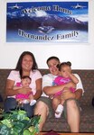 Petty Officer 1st Class Michael Hernandez, his wife Nellie, and daughters Emma, left, and Nina relax in their new home following a July 6 house fire.