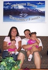 Petty Officer 1st Class Michael Hernandez, his wife Nellie, and daughters Emma, left, and Nina relax in their new home following a July 6 house fire.