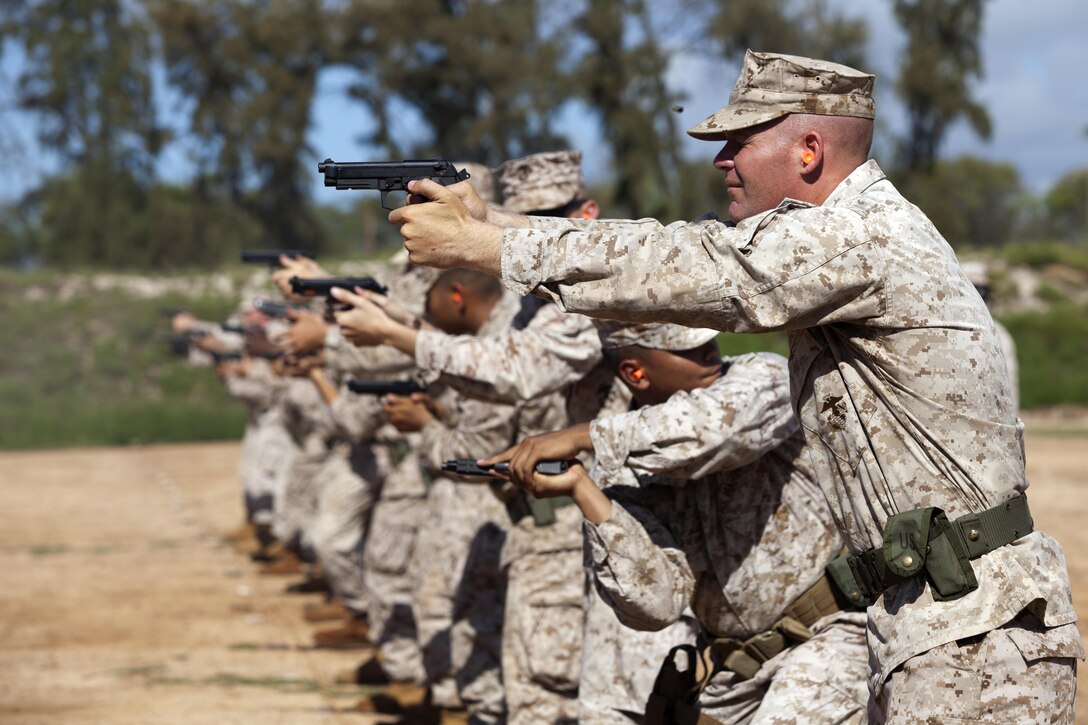 Marines fire rounds down range during Combat Pistol Program qualification training and firing at the Puuloa Range Training Facility in Ewa Beach, Hawaii, April 30, 2013. (U.S. Marine Corps photo by Lance Cpl. Nathan Knapke) 