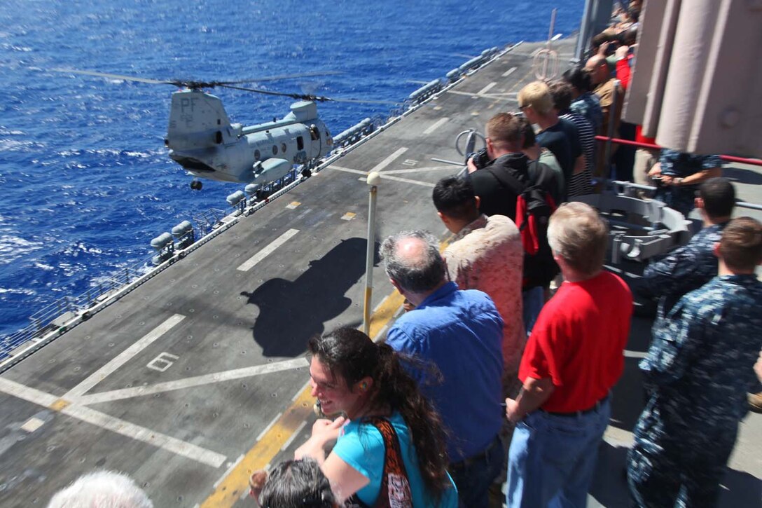 Servicemembers, their families and friends view an air-power display aboard USS Peleliu, May 9. During the last leg of the deployment, guests came aboard the ship to experience life on the Peleliu and to learn what their Marine or sailor has accomplished during the past seven months. The 15th Marine Expeditionary Unit is comprised of approximately 2,400 Marines and sailors and is deployed as part of the Peleliu Amphibious Ready Group. Together, they provide a forward-deployed, flexible sea-based Marine Air Ground Task Force capable of conducting a wide variety of operations ranging from humanitarian aid to combat. (U.S. Marine Corps photo by Cpl. Timothy Childers / Released)