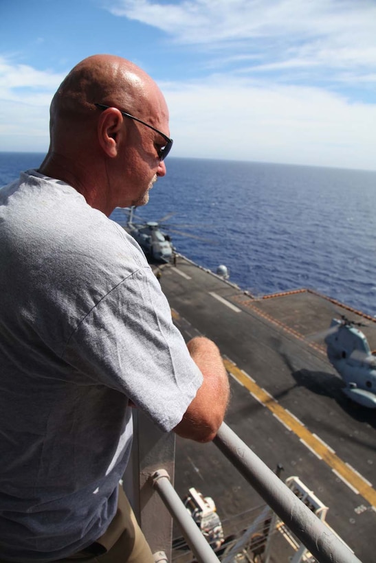 John Coolidge, father of Cpl. Dillon Coolidge, watches an air-power display aboard USS Peleliu, May 9. During the last leg of the deployment, guests came aboard the ship to experience life on the Peleliu and to learn what their Marine or sailor has accomplished during the past seven months. The 15th Marine Expeditionary Unit is comprised of approximately 2,400 Marines and sailors and is deployed as part of the Peleliu Amphibious Ready Group. Together, they provide a forward-deployed, flexible sea-based Marine Air Ground Task Force capable of conducting a wide variety of operations ranging from humanitarian aid to combat. (U.S. Marine Corps photo by Cpl. Timothy Childers / Released)