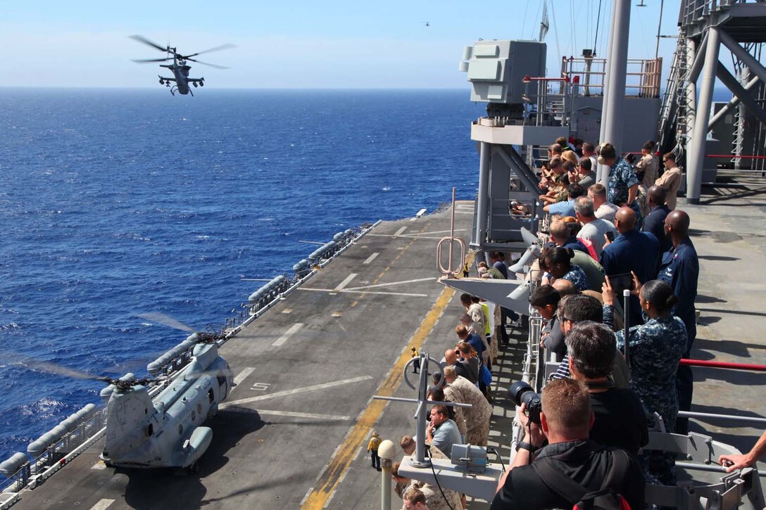 Service members, their families and friends view an air-power display aboard USS Peleliu, May 9. During the last leg of the deployment, guests came aboard the ship to experience life on the Peleliu and to learn what their Marine or sailor has accomplished during the past seven months. The 15th Marine Expeditionary Unit is comprised of approximately 2,400 Marines and sailors and is deployed as part of the Peleliu Amphibious Ready Group. Together, they provide a forward-deployed, flexible sea-based Marine Air Ground Task Force capable of conducting a wide variety of operations ranging from humanitarian aid to combat. (U.S. Marine Corps photo by Cpl. Timothy Childers / Released)